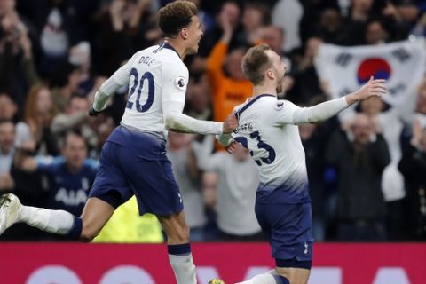 Tottenham's Christian Eriksen, center, celebrates with Tottenham's Dele Alli after Eriksen scored his side's first goal during the English Premier League soccer match between Tottenham Hotspur and Brighton & Hove Albion at Tottenham Hotspur stadium in London, Tuesday, April 23, 2019.(AP Photo/Frank Augstein)