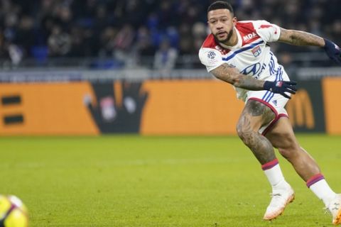 Lyon's Memphis Depay kicks the ball during a French League One soccer match against Reims in Decines, near Lyon, central France, Friday, Jan. 11, 2019. (AP Photo/Laurent Cipriani)