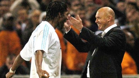 Marseille' coach Jose Anigo, right, congratules Didier Drogba during the UEFA cup semifinal, second-leg soccer match against Newcastle, Thursday, May 6  2004, in Marseille, southern France. Marseille won, 2-0.  (AP Photo/Patrick Gardin)