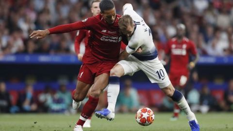 Tottenham's Harry Kane, right and Liverpool's Virgil Van Dijk challenge for the ball during the Champions League final soccer match between Tottenham Hotspur and Liverpool at the Wanda Metropolitano Stadium in Madrid, Saturday, June 1, 2019. (AP Photo/Bernat Armangue)