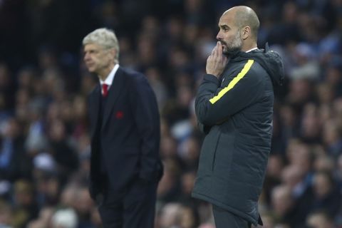 Arsenal manager Arsene Wenger, left, and Manchester City manager Pep Guardiola during the English Premier League soccer match between Manchester City and Arsenal at the Etihad Stadium in Manchester, England, Sunday, Dec. 18, 2016. (AP Photo/Dave Thompson)