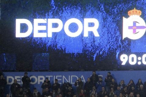Deportivo's fans celebrate under a board with the final score, after a Spanish La Liga soccer match between Deportivo and Barcelona at the Riazor stadium in A Coruna, Spain, Sunday, March 12, 2017. Deportivo won 2-1.(AP Photo/Paulo Duarte)
