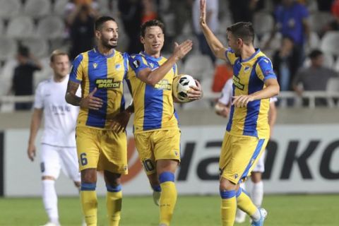 APOEL players celebrate a goal against Dudelange during the Europa League group A soccer match between APOEL Nicosia and Dudelange at GSP stadium in Nicosia, Cyprus, Thursday, Sept. 19, 2019. (AP Photo/Petros Karadjias)