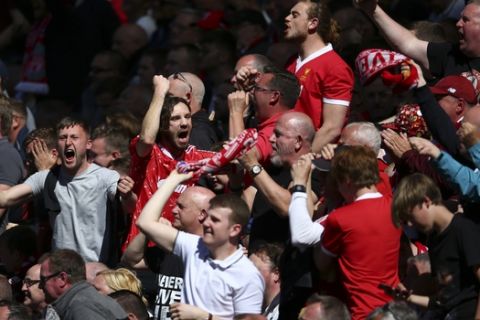 Liverpool supporters celebrate on stands during the English Premier League soccer match between Liverpool and Wolverhampton Wanderers at the Anfield stadium in Liverpool, England, Sunday, May 12, 2019. (AP Photo/Dave Thompson)