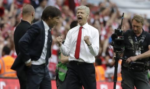 Arsenal team manager Arsene Wenger, right, celebrates his team's victory next to Chelsea team manager Antonio Conte, left, during the English FA Cup final soccer match between Arsenal and Chelsea at the Wembley stadium in London, Saturday, May 27, 2017. (AP Photo/Matt Dunham)