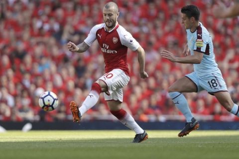 Arsenal's Jack Wilshere, left, competes for the ball with Burnley's Ashley Westwood during the English Premier League soccer match between Arsenal and Burnley at the Emirates Stadium in London, Sunday, May 6, 2018. The match is Arsenal manager Arsene Wenger's last home game in charge after announcing in April he will stand down as Arsenal coach at the end of the season after nearly 22 years at the helm. (AP Photo/Matt Dunham)