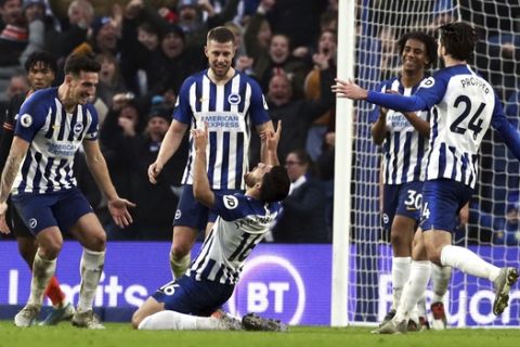 Brighton's Alireza Jahanbakhsh, centre, celebrates scoring his side's first goal of the game, during the English Premier League soccer match between Brighton and Chelsea at the AMEX Stadium, Brighton, England, Wednesday Jan. 1, 2020. (Gareth Fuller/PA via AP)
