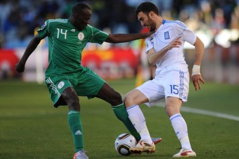Nigeria's midfielder Sani Kaita (L) challenges Greece's defender Vasilis Torosidis for the ball during the Group B first round 2010 World Cup football match Greece vs. Nigeria on June 17, 2010 at Free State Stadium in Mangaung/Bloemfontein. NO PUSH TO MOBILE / MOBILE USE SOLELY WITHIN EDITORIAL ARTICLE  -   AFP PHOTO / RODRIGO ARANGUA (Photo credit should read RODRIGO ARANGUA/AFP/Getty Images)