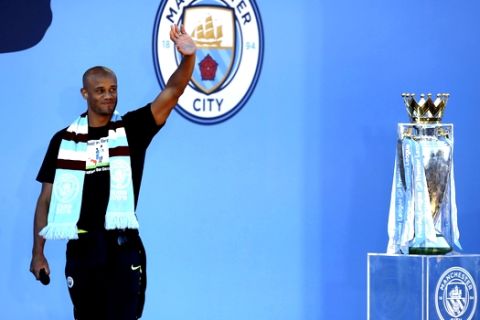 Manchester City's Vincent Kompany waves to fans during the trophy parade in Manchester, England, Monday May 20, 2019, after winning the English FA Cup. Victory for Pep Guardiolas side came a week after the English Premier League trophy was retained to join the League Cup and Community Shield already in Citys possession. (Nick Potts/PA via AP)