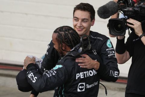 Mercedes driver Lewis Hamilton, of Britain, front, congratulates teammate George Russell, of Britain,  after winning the Sprint Race qualifying session at the Interlagos racetrack, in Sao Paulo, Brazil, Saturday, Nov. 12, 2022. The Brazilian Formula One Grand Prix will take place on Sunday. (AP Photo/Andre Penner)