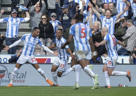 Huddersfield Town's Thomas Ince, left, celebrates scoring his side's first goal of the game during the English Premier League soccer match between Huddersfield Town and Watford at the John Smith's Stadium, Huddersfield, England, Saturday April 14, 2018.(Dave Howarth/PA via AP)
