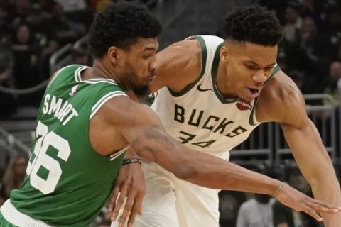 Milwaukee Bucks' Giannis Antetokounmpo and Boston Celtics' Marcus Smart go after a loose ball during the first half of Game 5 of a second round NBA basketball playoff series Wednesday, May 8, 2019, in Milwaukee. (AP Photo/Morry Gash)