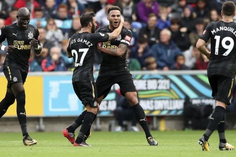 Newcastle United's Jamaal Lascelles, center right, celebrates scoring against Swansea City during the English Premier League soccer match at the Liberty Stadium, Swansea, Wales, Sunday Sept. 10, 2017. (Nick Potts/PA via AP)