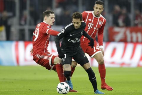 PSG's Neymar is challenged by Bayern's Sebastian Rudy, left, and Corentin Tolisso during the Champions League Group B soccer match between FC Bayern Munich and Paris Saint-Germain, at Allianz Arena stadium in Munich, Germany, Tuesday, Dec. 5, 2017. (AP Photo/Matthias Schrader)