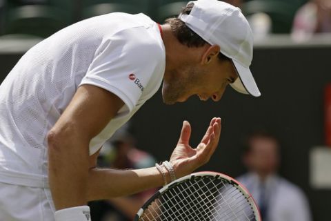 Austria's Dominic Thiem reacts as he plays United States' Sam Querrey in a Men's singles match during day two of the Wimbledon Tennis Championships in London, Tuesday, July 2, 2019. (AP Photo/Tim Ireland)