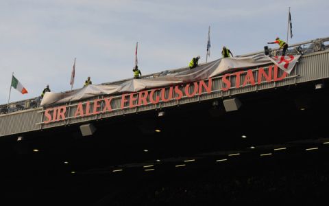 MANCHESTER, ENGLAND - NOVEMBER 05: Workmen reveal the sign for the Sir Alex Ferguson Stand during the Barclays Premier League match between Manchester United and Sunderland at Old Trafford on November 5, 2011 in Manchester, England.  (Photo by Michael Regan/Getty Images)