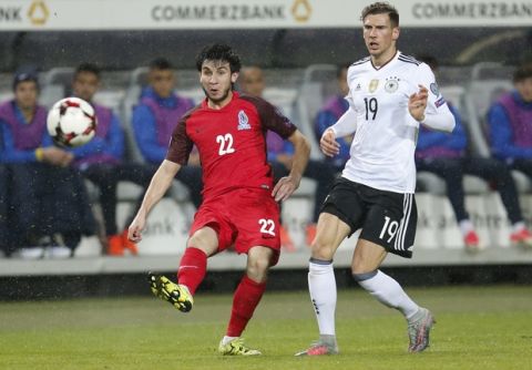 Germany's Leon Goretzka, right, looks on as Azerbaijan's Afran Ismailov kicks a ball during the 2018 World Cup qualifying Group C soccer match between Germany and Azerbaijan in Kaiserslautern, Germany, Sunday, Oct. 8, 2017.(AP Photo/Michael Probst)