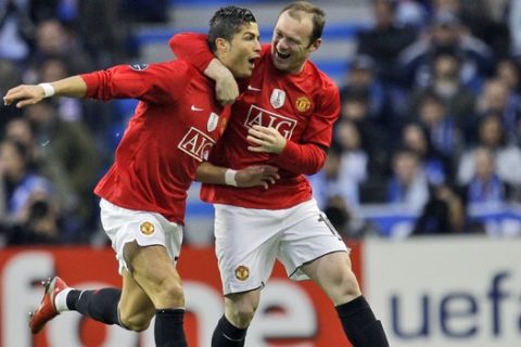 Manchester United's Cristiano Ronaldo, left,  celebrates with Wayne Rooney after scoring the opening goal against FC Porto during their Champions League quarter final second leg, soccer match Wednesday, April 15 2009, at the Dragao stadium in Porto, northern Portugal. (AP Photo / Armando Franca)