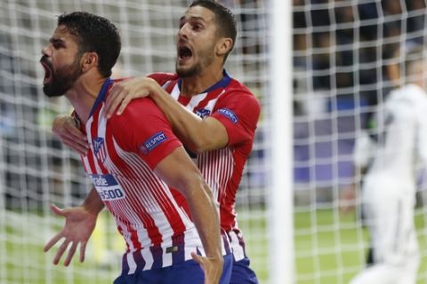 Atletico's Diego Costa, left, celebrates with teammate Atletico's Koke, right, after scoring his sides first goal during the UEFA Super Cup final soccer match between Real Madrid and Atletico Madrid at the Lillekula Stadium in Tallinn, Estonia, Wednesday, Aug. 15, 2018. (AP Photo/Pavel Golovkin)