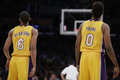 Los Angeles Lakers' Jordan Clarkson, left, and Nick Young look on during the first half of an NBA preseason basketball game against the Maccabi Haifa on Sunday, Oct. 11, 2015, in Los Angeles. (AP Photo/Jae C. Hong)