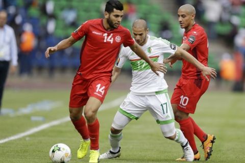 Algeria's Rachid Ghezzal, center, is challenged by Tunisia's Mohamed Amine Ben Amor, left, and Wahbi Khazri during their African Cup of Nations Group B soccer match at Stade de Franceville Stadium in Franceville, Gabon Thursday Jan. 19, 2017. (AP Photo/Sunday Alamba)