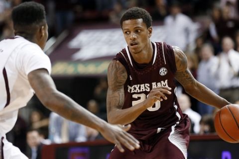 Texas A&M guard Jamal Jones (23) looks for an open teammate as Mississippi State guard Fred Thomas defends in overtime of an NCAA college basketball game in Starkville, Miss., Saturday, Jan. 18, 2014. Mississippi State won 81-72 in overtime.  (AP Photo/Rogelio V. Solis)