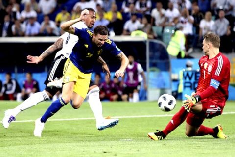 Germany goalkeeper Manuel Neuer, right, makes a save in front of Sweden's Marcus Berg, center, during the group F match between Germany and Sweden at the 2018 soccer World Cup in the Fisht Stadium in Sochi, Russia, Saturday, June 23, 2018. (AP Photo/Thanassis Stavrakis)