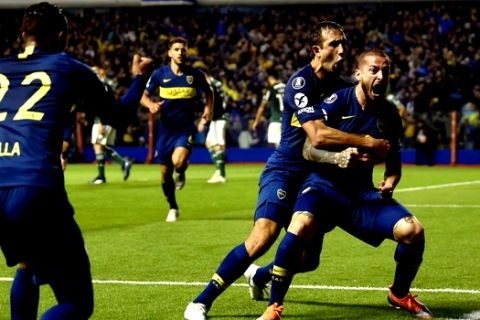 Dario Benedetto of Argentina's Boca Juniors, right, celebrates his first of two goals against Brazil's Palmeiras during a Copa Libertadores semifinal first leg soccer match in Buenos Aires, Argentina, Wednesday, Oct. 24, 2018. Boca won 2-0. (AP Photo/Gustavo Garello)