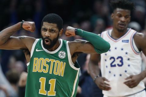 Boston Celtics' Kyrie Irving (11) reacts in front of Philadelphia 76ers' Jimmy Butler after making a 3-pointer in overtime during an NBA basketball game in Boston, Tuesday, Dec. 25, 2018. Boston won 121-114. (AP Photo/Michael Dwyer)