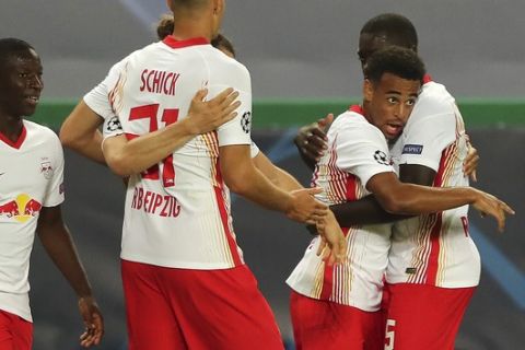 Leipzig's Tyler Adams, right, celebrates after scoring his side's second goal during the Champions League quarterfinal match between RB Leipzig and Atletico Madrid at the Jose Alvalade stadium in Lisbon, Portugal, Thursday, Aug. 13, 2020. (Miguel A. Lopes/Pool Photo via AP)