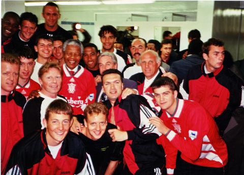 Nelson Mandela president of South Africa is surrounded by the players and management, including Roy Evans the manager and Ronnie Moran, of Liverpool FC in the dressing room at (LOCATION?). (DATE?)
(photo; John Cocks)