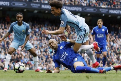Manchester City's Leroy Sane is brought down inside the box by Leicester's Yohan Benalouane resulting in a penalty, during the English Premier League soccer match between Manchester City and Leicester, at the Etihad Stadium, in Manchester, England, Saturday May 13, 2017. (Martin Rickett/PA via AP)