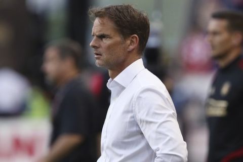FILE - In this May 19, 2019, file photo, Atlanta United coach Frank de Boer watches during the second half of the team's MLS soccer match against the New York Red Bulls in Harrison, N.J. De Boer said he regrets his choice of words in a British newspaper interview about gender equity in soccer and stressed that he's a big supporter of the women's game. De Boer faced backlash before Wednesday's Campeones Cup game for his comments in an article published by The Guardian, in which he said it was "ridiculous" that female players expect to receive the same World Cup pay as the men. (AP Photo/Steve Luciano, File)