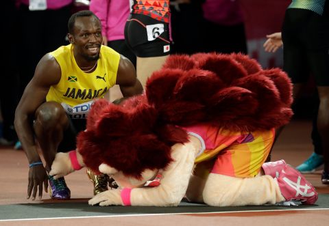 Jamaica's Usain Bolt smiles next to mascot Hero the Hedgehog after his men's 100m heat the World Athletics Championships in London Friday, Aug. 4, 2017. (AP Photo/Matthias Schrader)