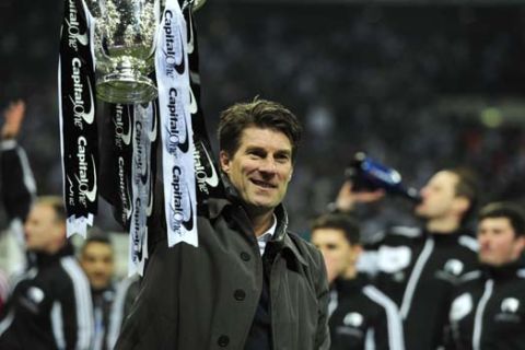 Swansea City's Danish manager Michael Laudrup celebrates with the trophy after the League Cup final football match between Bradford City and Swansea City at Wembley Stadium in London, England on February 24, 2013. Swansea city won the game 5-0. AFP PHOTO/GLYN KIRK
                                                                                                             
RESTRICTED TO EDITORIAL USE. No use with unauthorized audio, video, data, fixture lists, club/league logos or ?live? services. Online in-match use limited to 45 images, no video emulation. No use in betting, games or single club/league/player publications.        (Photo credit should read GLYN KIRK,GLYN KIRK/AFP/Getty Images)