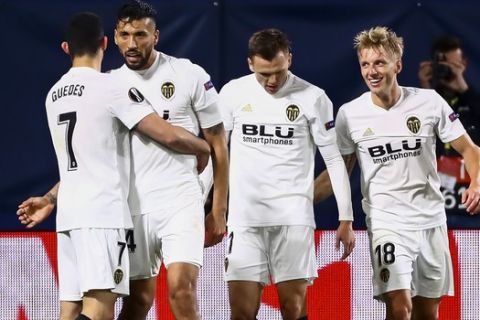 Gonzalo Guedes, left, celebrates with team mates from 2nd left to right; Ezequiel Garay, Denis Cheryshev and Daniel Wass during the quarterfinal, 1st leg, Europa League soccer match between Villarreal and Valencia at the Ceramica stadium in Villarreal, Spain, Thursday April 11, 2019. (AP Photo/Jose Miguel Fernandez de Velasco)
