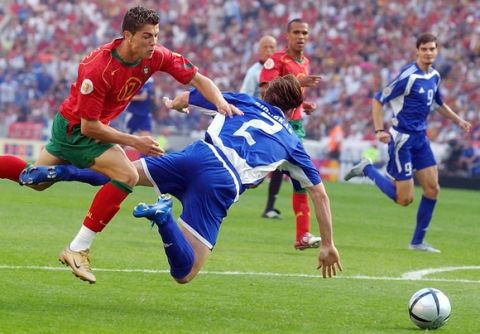 Georgios Seitaridis of Greece (2 in blue) is fouled by Cristiano Ronaldo of Portugal, left, during their Euro 2004, Group A, soccer match at the Dragao stadium in Porto, Portugal, Saturday June 12, 2004. Other teams in group A are Spain and Russia. Greece scored the ensuing penalty kick. (AP Photo/Dusan Vranic)