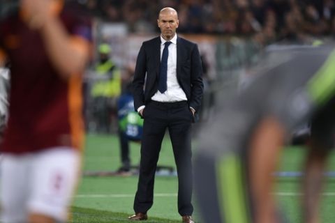 Real Madrid's French coach Zinedine Zidane looks on during the UEFA Champions League football match AS Roma vs Real Madrid on Frebruary 17, 2016 at the Olympic stadium in Rome.   AFP PHOTO / ALBERTO PIZZOLI / AFP / ALBERTO PIZZOLI        (Photo credit should read ALBERTO PIZZOLI/AFP/Getty Images)