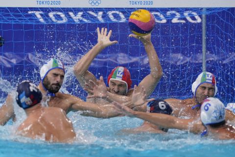 Italy's goalkeeper Marco del Lungo reaches for a shot by Serbia's Andrija Prlainovic (11) during a quarterfinal round men's water polo match at the 2020 Summer Olympics, Wednesday, Aug. 4, 2021, in Tokyo, Japan. (AP Photo/Mark Humphrey)