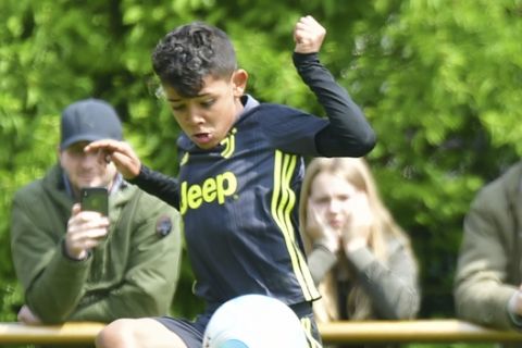 CORRECT DATE - In this Saturday May 11, 2019 photo, Cristiano Ronaldo junior, the son of Portuguese soccer player Cristiano Ronaldo, plays the ball during a junior soccer tournament for teams under the age of nine Kempen-Toenisberg under nine yea. (Norbert Pruemen/dpa via AP)