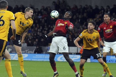 Manchester United's Paul Pogba, center right, controls the ball during the English Premier League soccer match between Wolverhampton Wanderers and Manchester United at the Molineux Stadium in Wolverhampton, England, Tuesday, April 2, 2019. (AP Photo/Rui Vieira)
