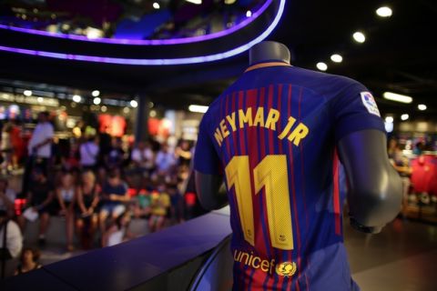 A t-shirt with the name of FC Barcelona's Neymar is displayed in a store of the Camp Nou stadium in Barcelona, Spain, Wednesday, Aug. 2, 2017. Neymar has told Barcelona that he plans to leave the club, with a blockbuster move to Paris Saint-Germain seemingly imminent. (AP Photo/Manu Fernandez)