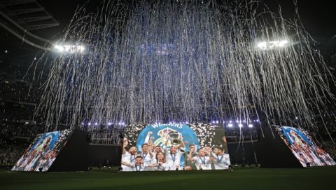 Real Madrid supporters watch on big screens placed at the team's Santiago Bernabeu stadium in Madrid, Spain, for the celebration of their team winning the Champions League final match against Liverpool played in Kiev, Ukraine,  Saturday, May 26, 2018. Real Madrid won 3-1. (AP Photo/Francisco Seco)