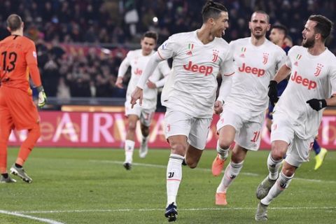 Cristiano Ronaldo of Juventus, center, celebrates after scoring a goal during the Serie A soccer match between Roma and Juventus at the Stadio Olimpico in Rome Sunday Jan. 12, 2020. (Alfredo Falcone, LaPresse via AP)