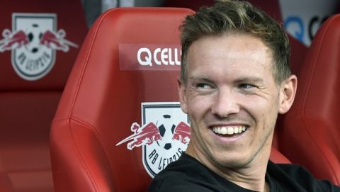 Leipzig's head coach Julian Nagelsmann sits on the substitute's bench prior to the German Bundesliga soccer match between RB Leipzig and FC Schalke 04 in Leipzig, Germany, Saturday, Sept. 28, 2019. (AP Photo/Jens Meyer)