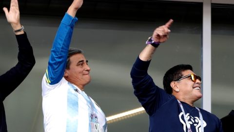 Former soccer star Diego Maradona, right, cheers Argentina's team as he attends the group D match between Argentina and Iceland at the 2018 soccer World Cup in the Spartak Stadium in Moscow, Russia, Saturday, June 16, 2018. (AP Photo/Ricardo Mazalan)
