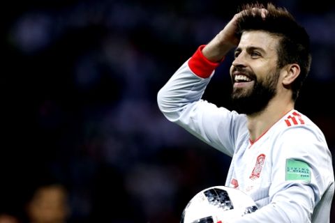 Spain's Gerard Pique holds the ball during the group B match between Iran and Spain at the 2018 soccer World Cup in the Kazan Arena in Kazan, Russia, Wednesday, June 20, 2018. (AP Photo/Manu Fernandez)