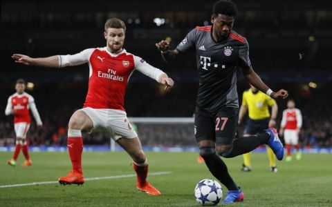 Bayern's David Alaba, right, challenges for the ball with Arsenal's Shkodran Mustafi during the Champions League round of 16 second leg soccer match between Arsenal and Bayern Munich at the Emirates Stadium in London, Tuesday, March 7, 2017. (AP Photo/Kirsty Wigglesworth)