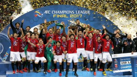Japan's Urawa Reds players celebrate on the podium after defeating Saudi Arabia's Al Hilal in the final of the AFC Champions League soccer tournament in Saitama, north of Tokyo, Saturday, Nov. 25, 2017. (AP Photo/Shuji Kajiyama)