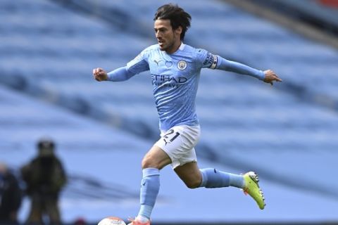 Manchester City's David Silva controls the ball during the English Premier League soccer match between Manchester City and Norwich City at the Etihad Stadium in Manchester, England, Sunday, July 26, 2020. (Shaun Botterill/Pool via AP)